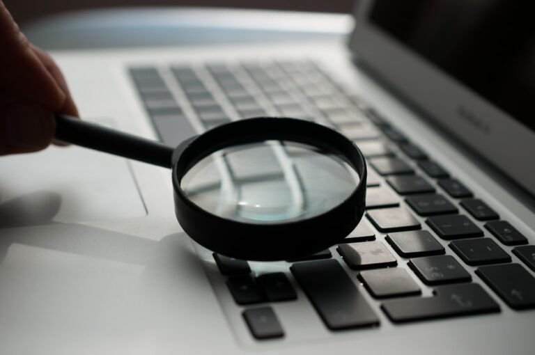 magnifying glass near a laptop
